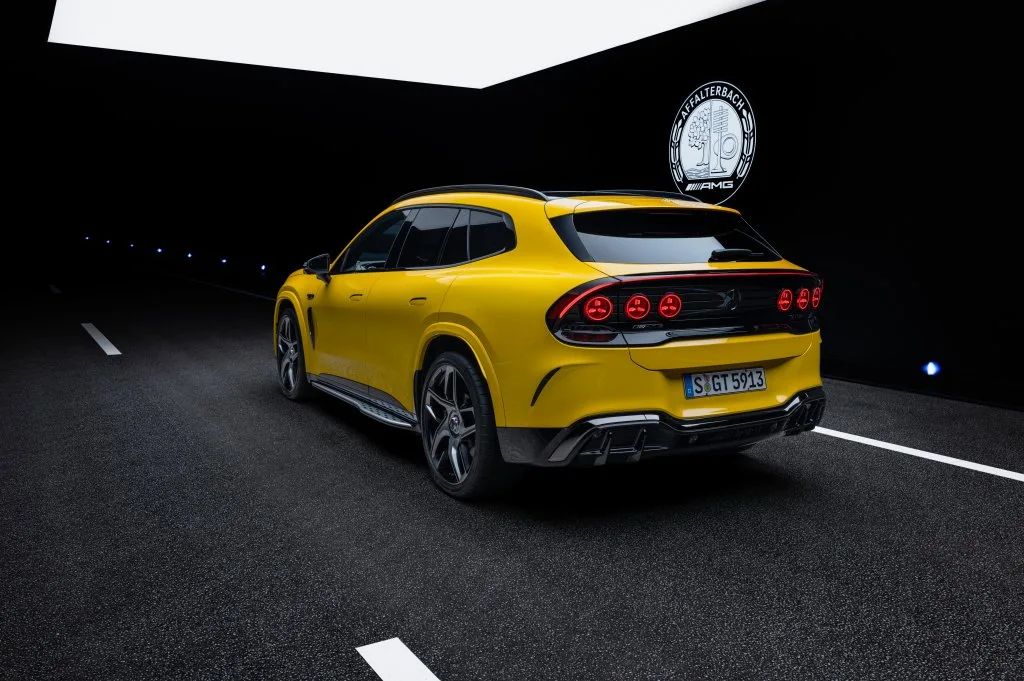 A yellow Mercedes-AMG GT SUV from the rear three-quarter view, showing its six round red taillights and sloping roofline