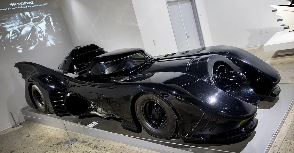 The Tim Burton-era Batmobile from the side, on display at a museum