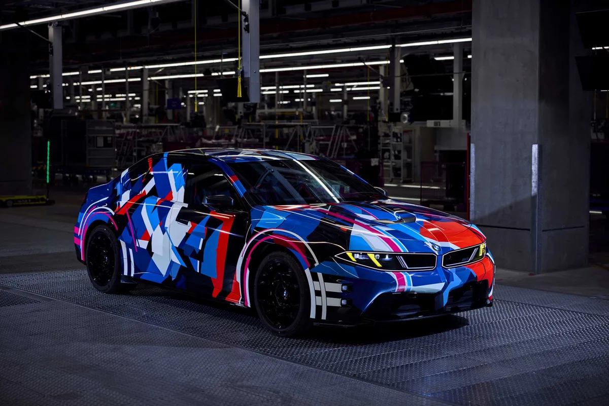 BMW shows the electric M3 in a thin M wrap as it builds its millionth M car