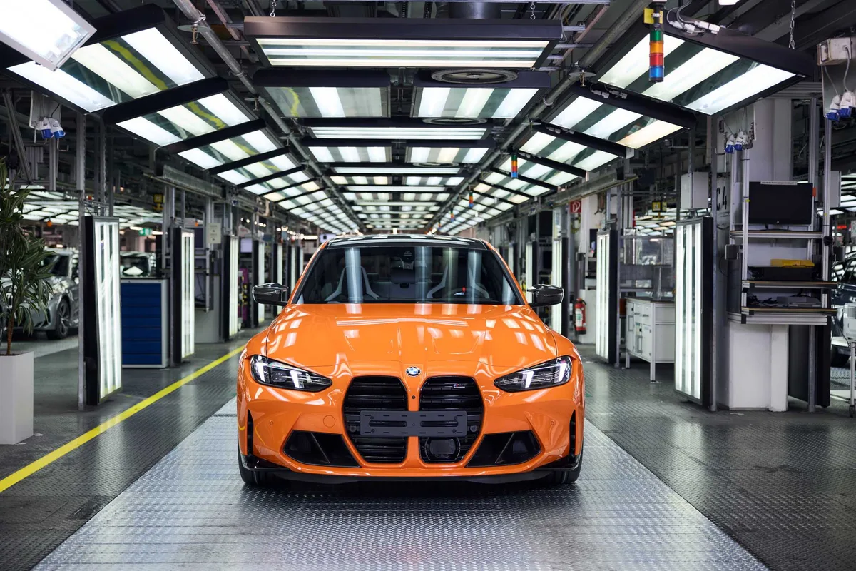 The one-millionth BMW M car, a Fire Orange III M3 Competition, seen head-on in the Munich plant