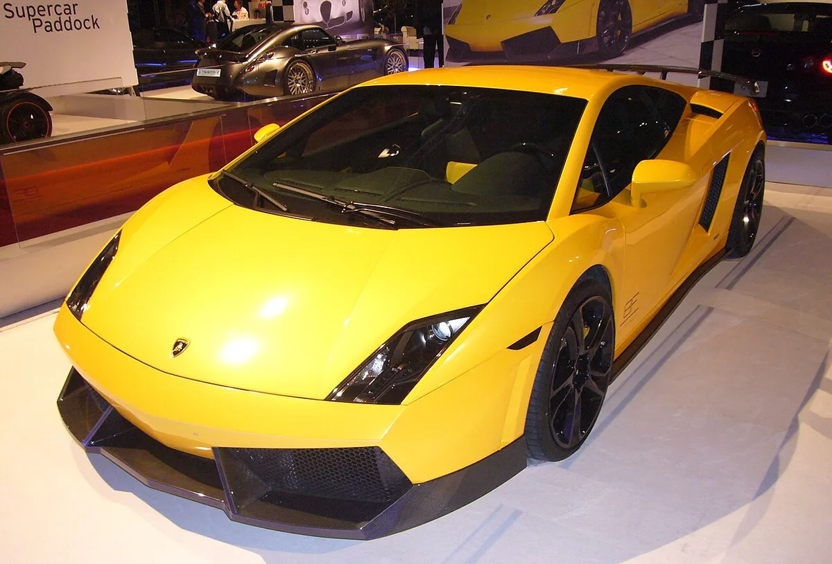A yellow Lamborghini Gallardo LP 560-4 coupe on display at an auto show, seen from the front