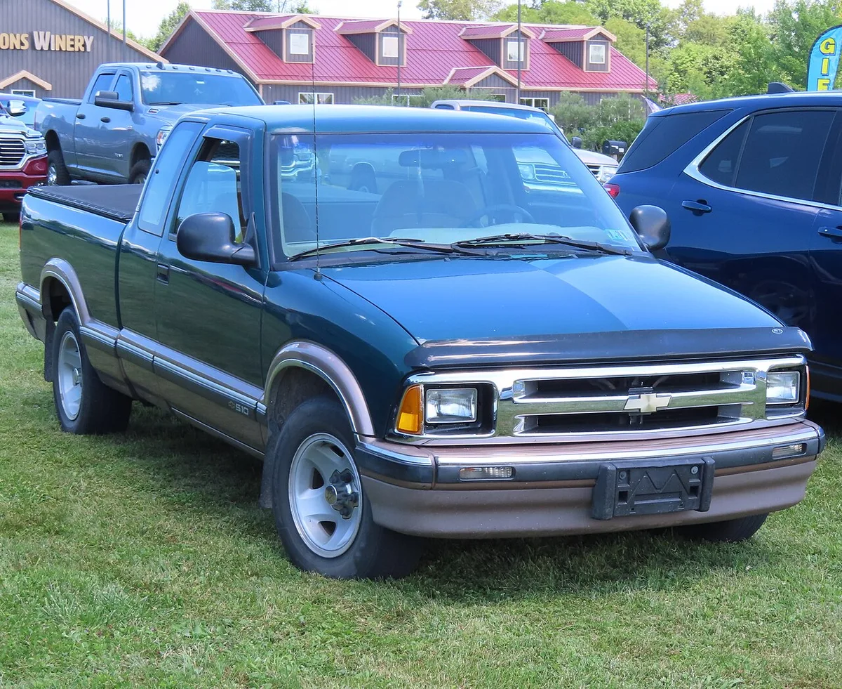 A green 1996 Chevrolet S-10 LS extended cab pickup seen from the front three-quarter angle, with its chrome grille and rectangular headlamps