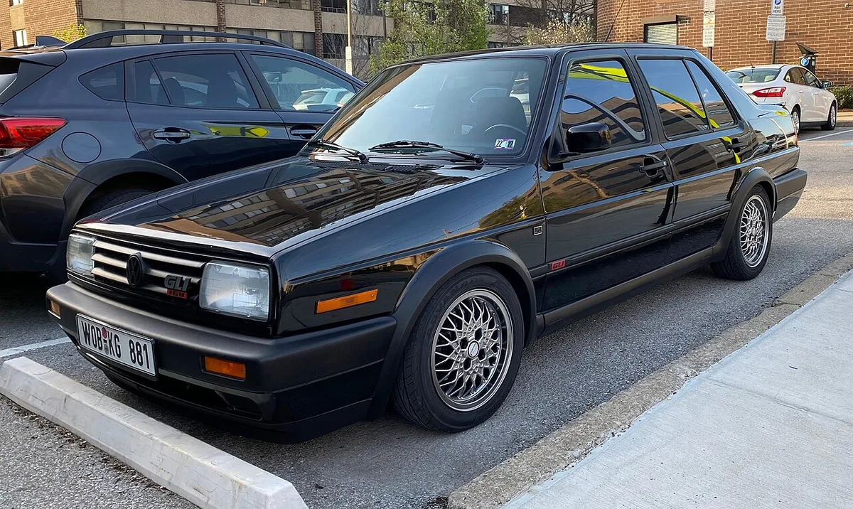 A black 1990 Volkswagen Jetta GLI from the front three-quarter view