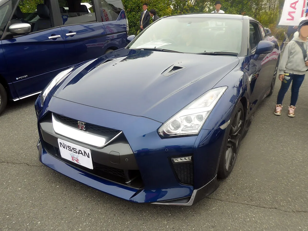 A blue Nissan GT-R R35 seen from the front three-quarter angle