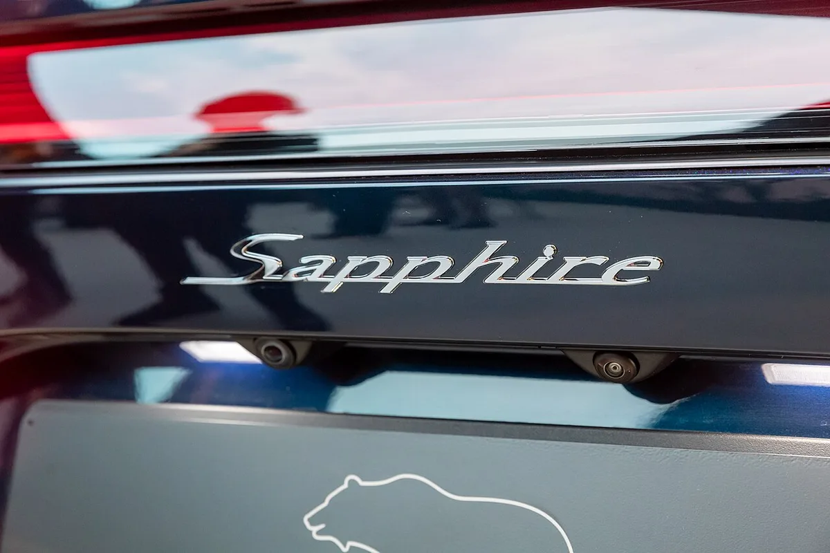 Sapphire script badge and Lucid bear logo on the trunk lid of a Lucid Air Sapphire