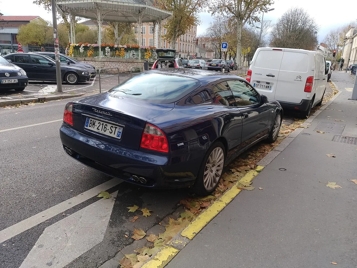A dark blue Maserati 4200 GT from the rear, with conventional taillights