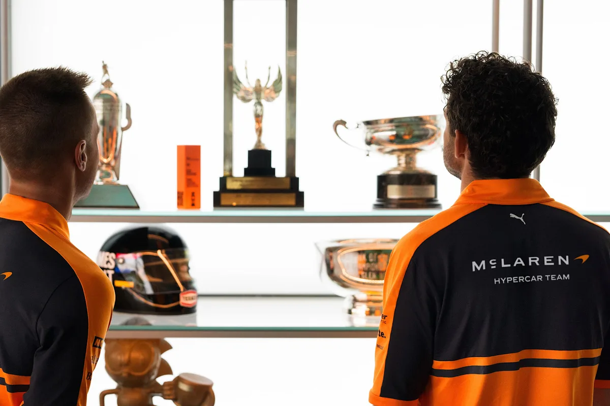 A McLaren Hypercar team shirt with the new wordmark, in front of a trophy case