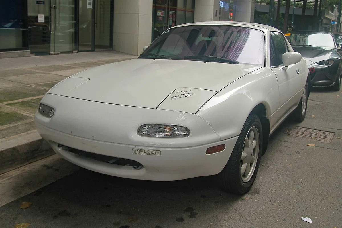 A 1991 Mazda MX-5 Miata hardtop in Crystal White