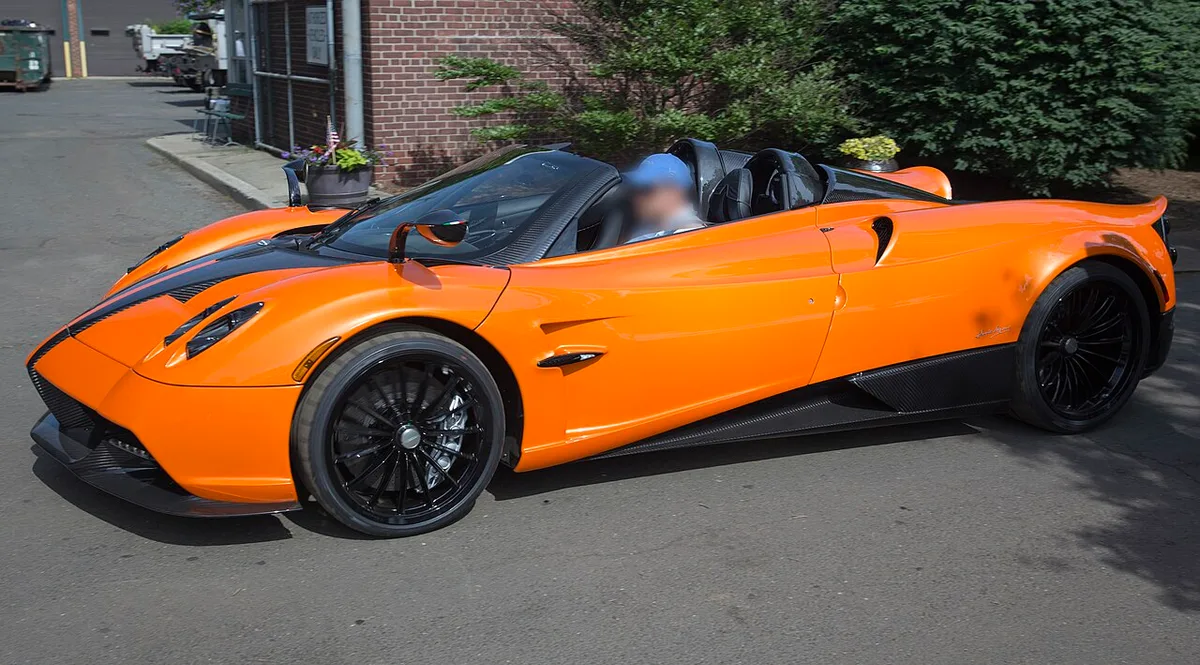 An orange Pagani Huayra Roadster from the front three-quarter view