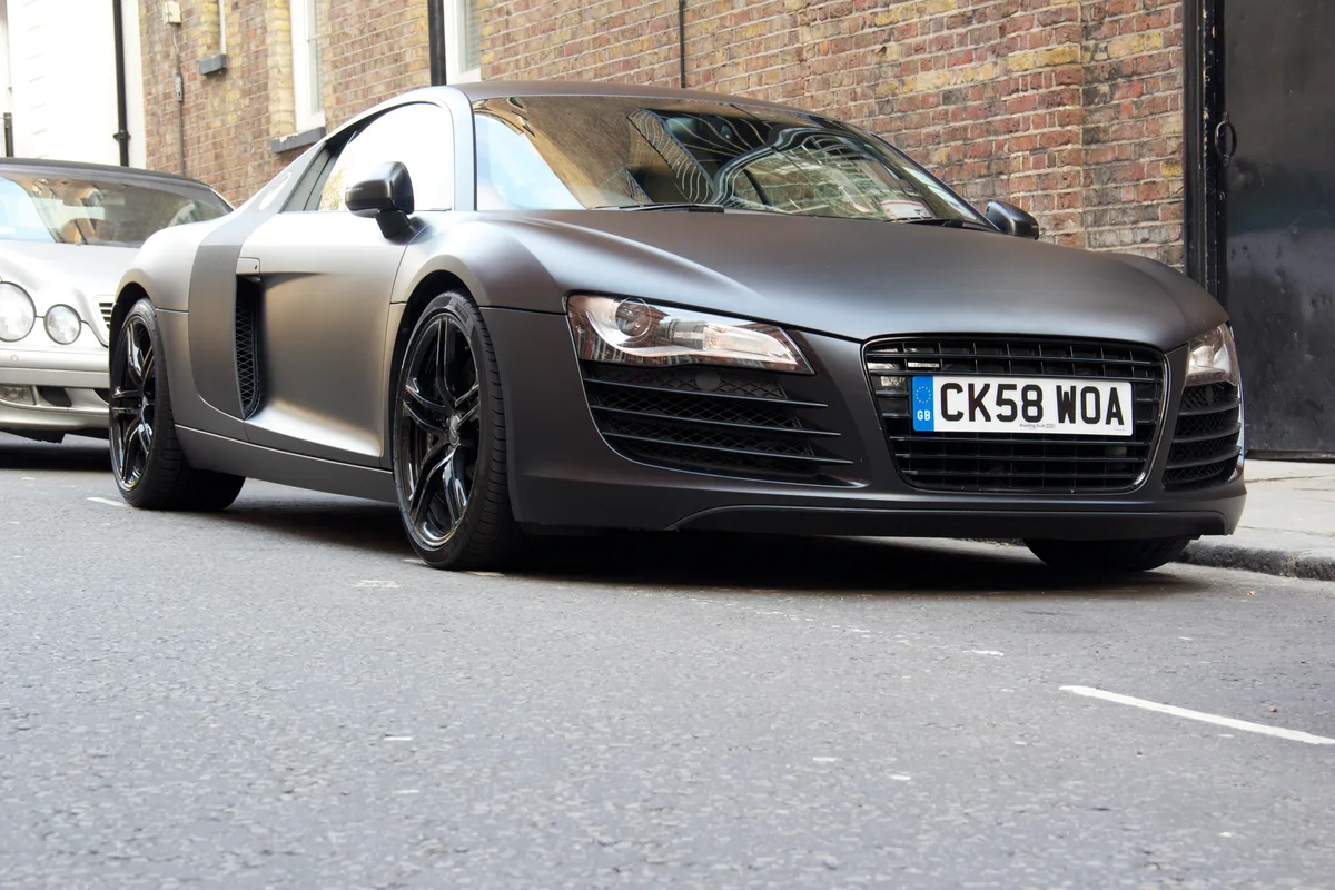 An Audi R8 in matte black paint with no reflections on its bodywork