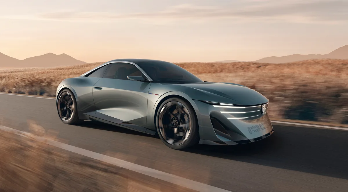 The silver Peugeot RCZ Vision concept coupe driving toward the camera on a desert road
