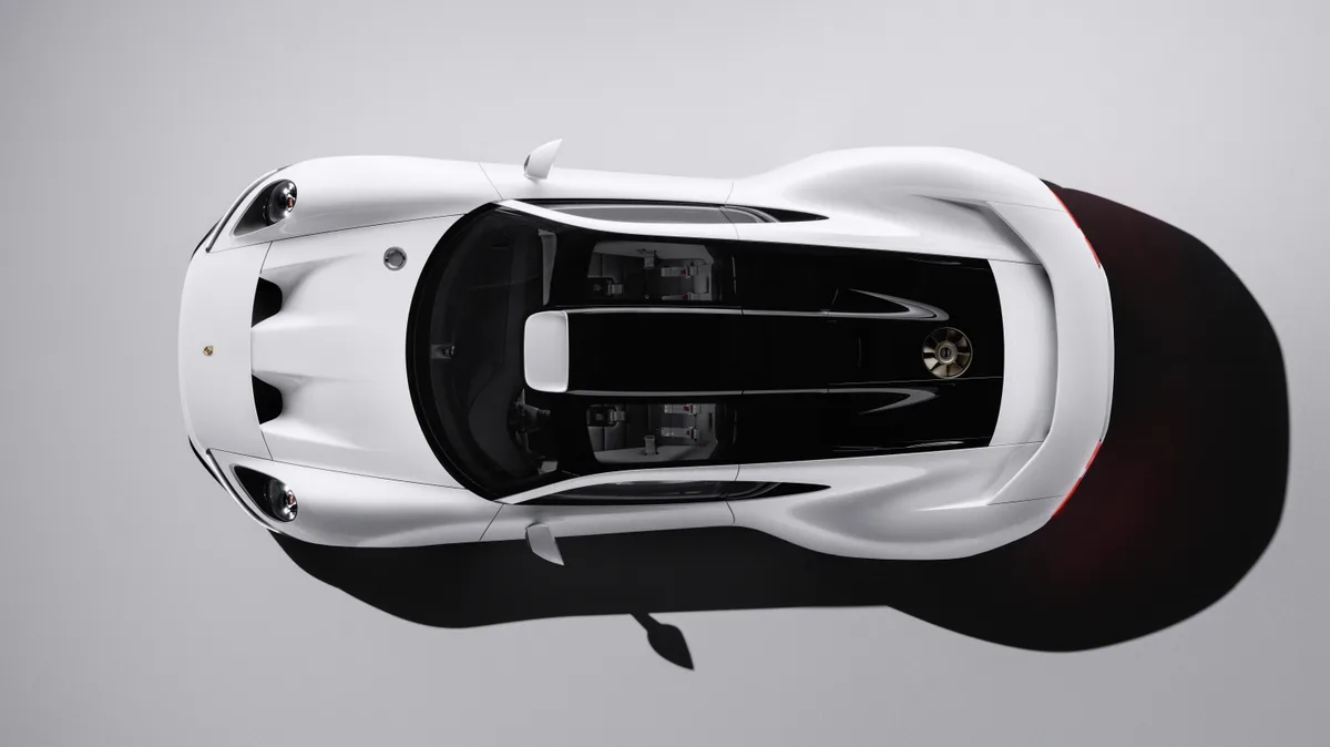 Overhead view of the white Porsche Mission S, showing the round headlights, the dark glass canopy, and the small cooling fan in the engine cover