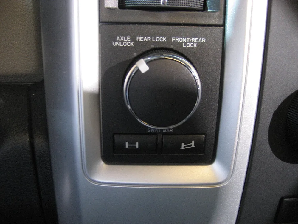The locker dial on an older Ram Power Wagon, with settings for Axle Unlock, Rear Lock, and Front/Rear Lock above two sway bar buttons